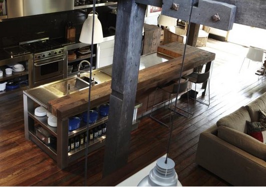 Wooden flooring, wooden countertop to soften stainless steel and concrete for industrial kitchen look