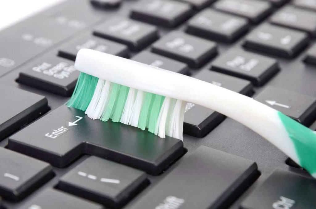 toothbrush to clean keyboard