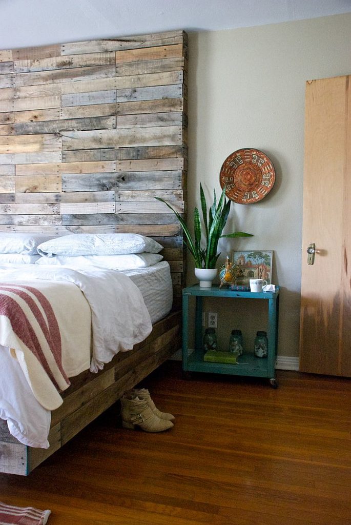 Creative reclaimed wood full height headboard for a contemporary bedroom design