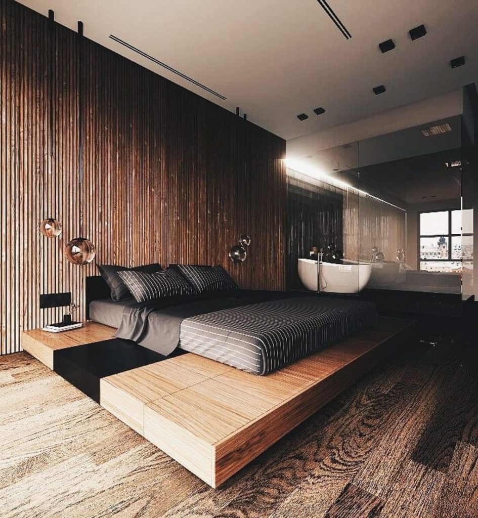 Dark Strip Vertical Wooden Wall Gives This Bedroom makes the already tall room feels taller. Hanging Crystal Ball on either Side of the bed gives this bedroom an ultra modern feel. The bed is essentially a large floating platform finished in lighter tone. 