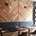 Elegant restaurant with herringbone wood walls offset