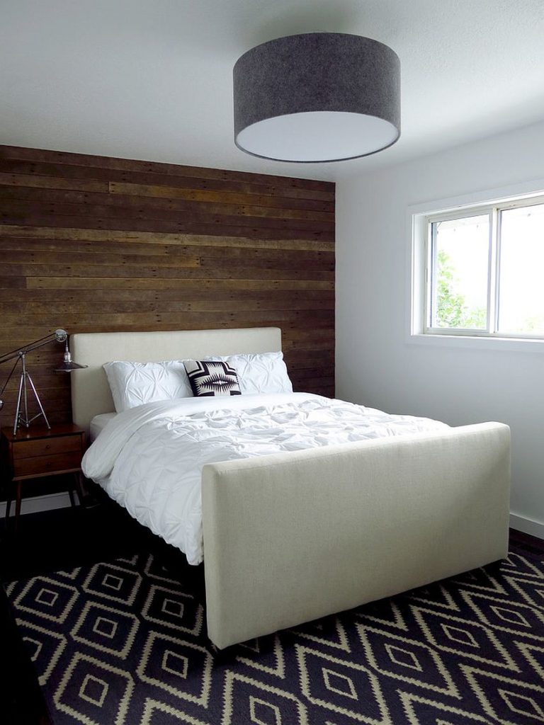 Works just as well in short rooms. Reclaimed wood feature wall adds charm to any bedroom from small to big