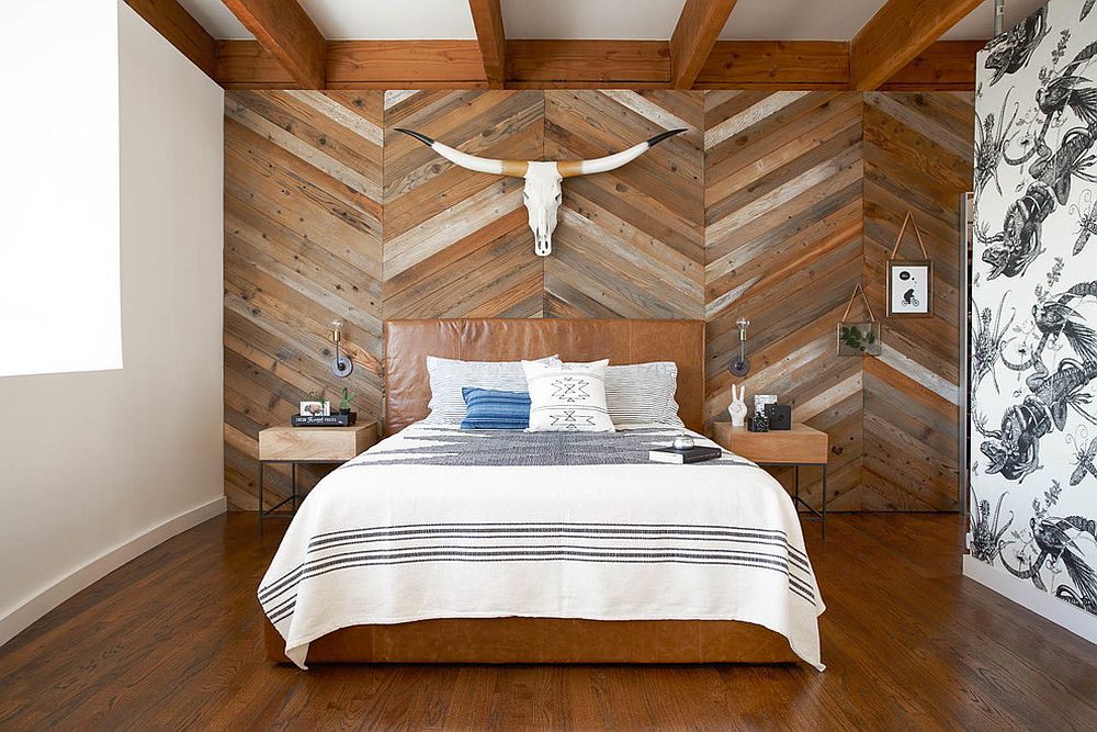 Reclaimed wood wall with chevron pattern on the wall behind the bed