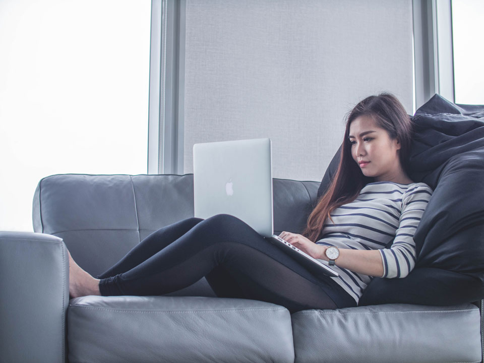 girl working from home on sofa