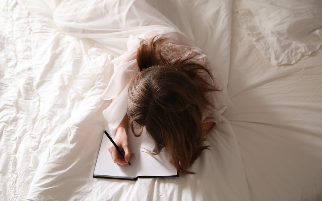 woman-journaling-in-bed
